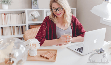 Woman in sweater enjoying cozy home office on a budget